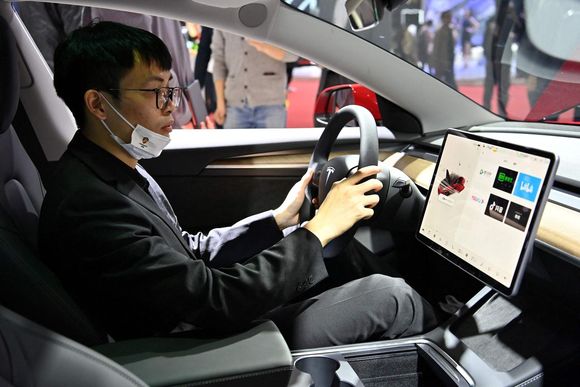 v929dh a man is seen inside of a tesla car during the 19th shanghai international automobile industry exhibition in shanghai on april 19 2021 20240427132716