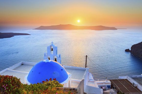 fvwlov sunset in santorini greece with blue domed church in the foreground 20240209152141