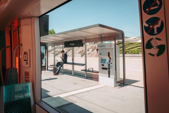 fm7mae a man in a suit waits for his tram in the kirchberg area in luxembourg where some of the big four have their offices 20240612113609